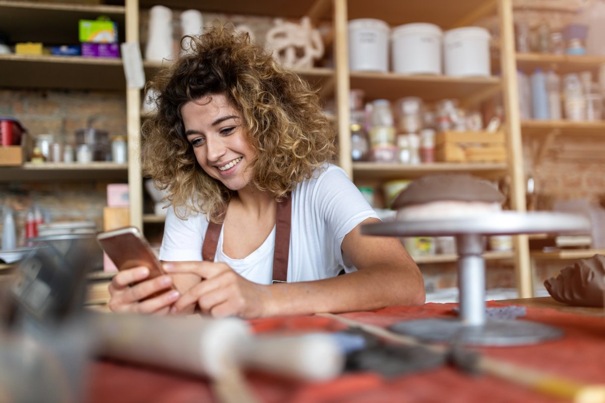 Woman holding her phone and smiling